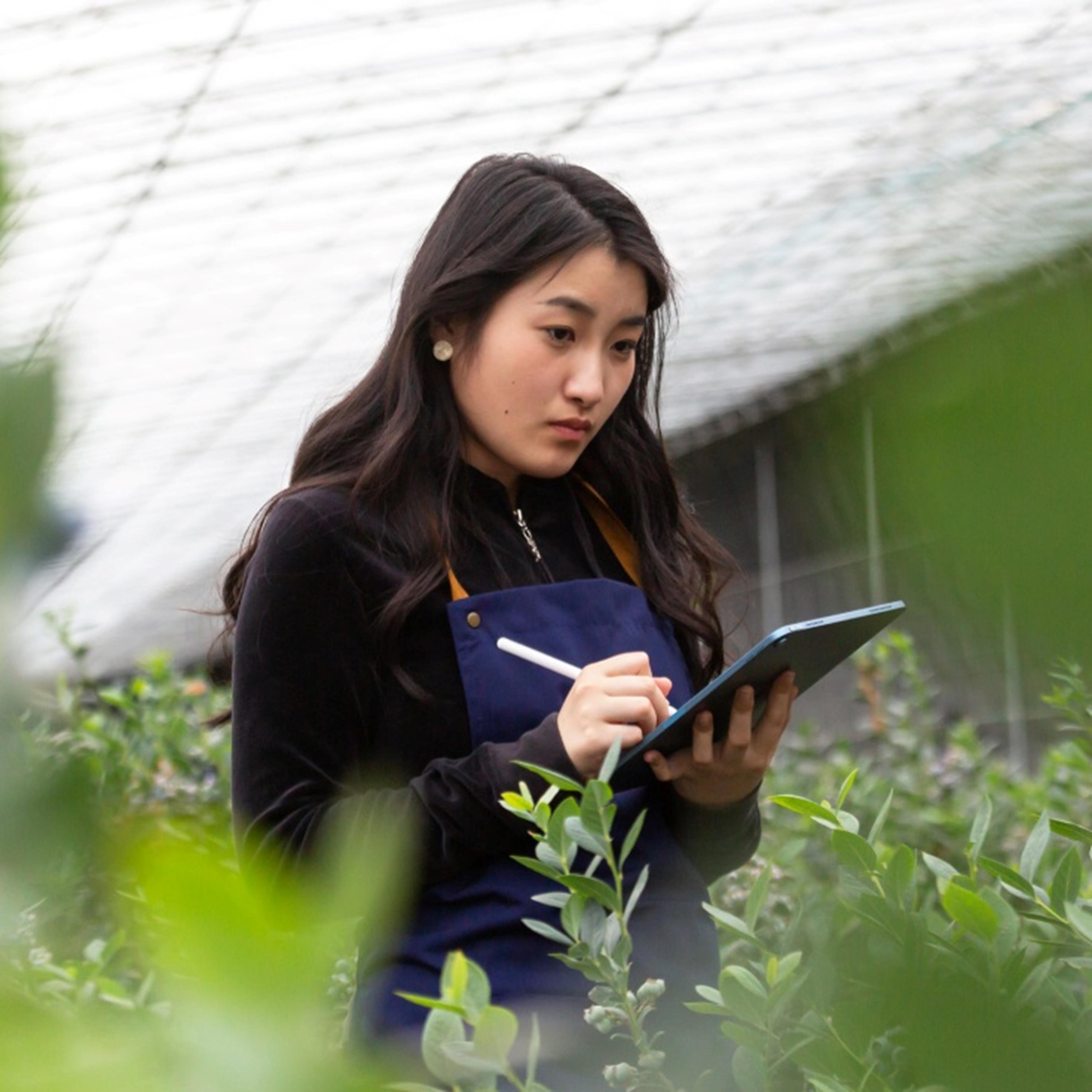 Woman observing plants